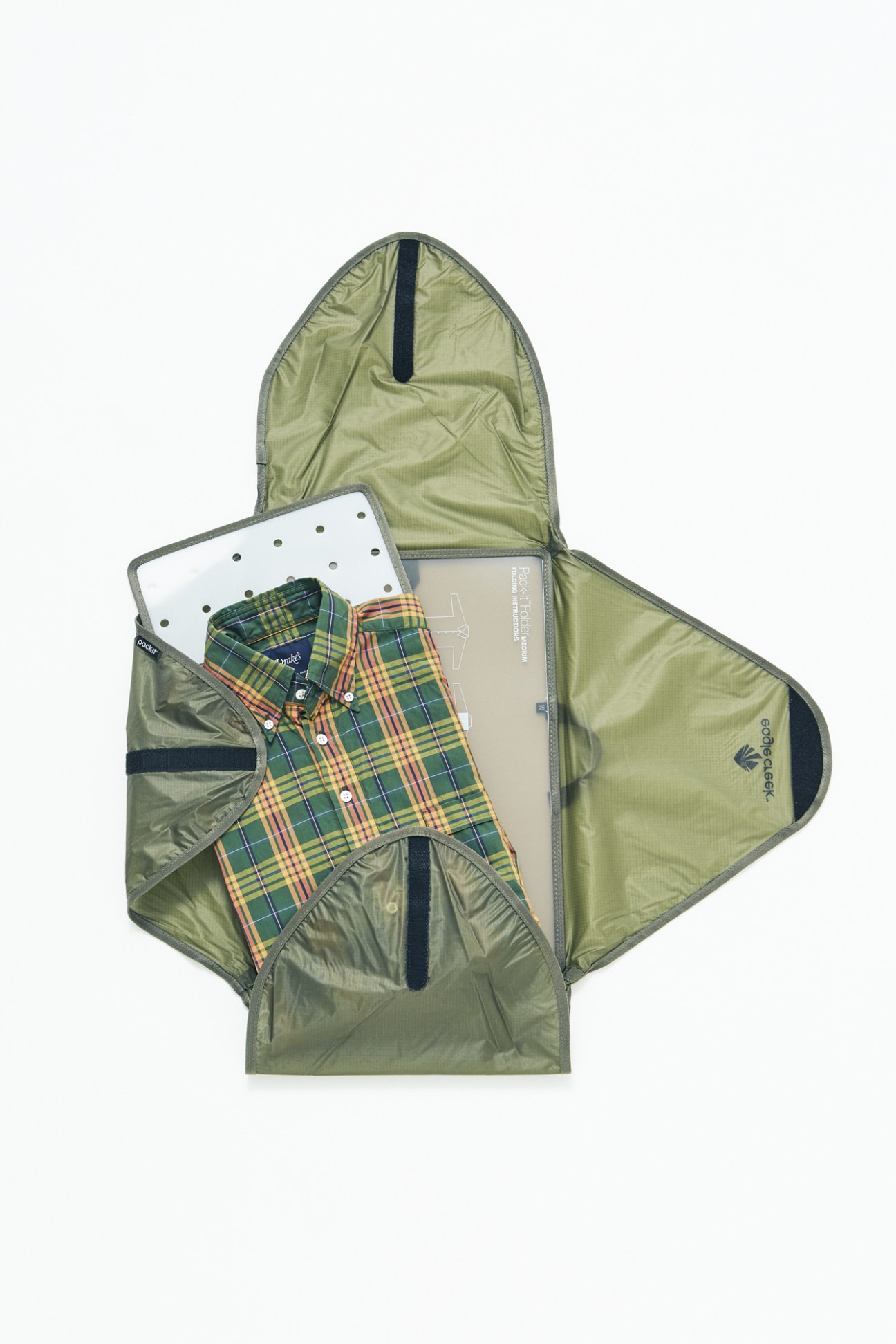 Open green garment holder by Eagle Creek displaying a checkered shirt by Drake's inside.