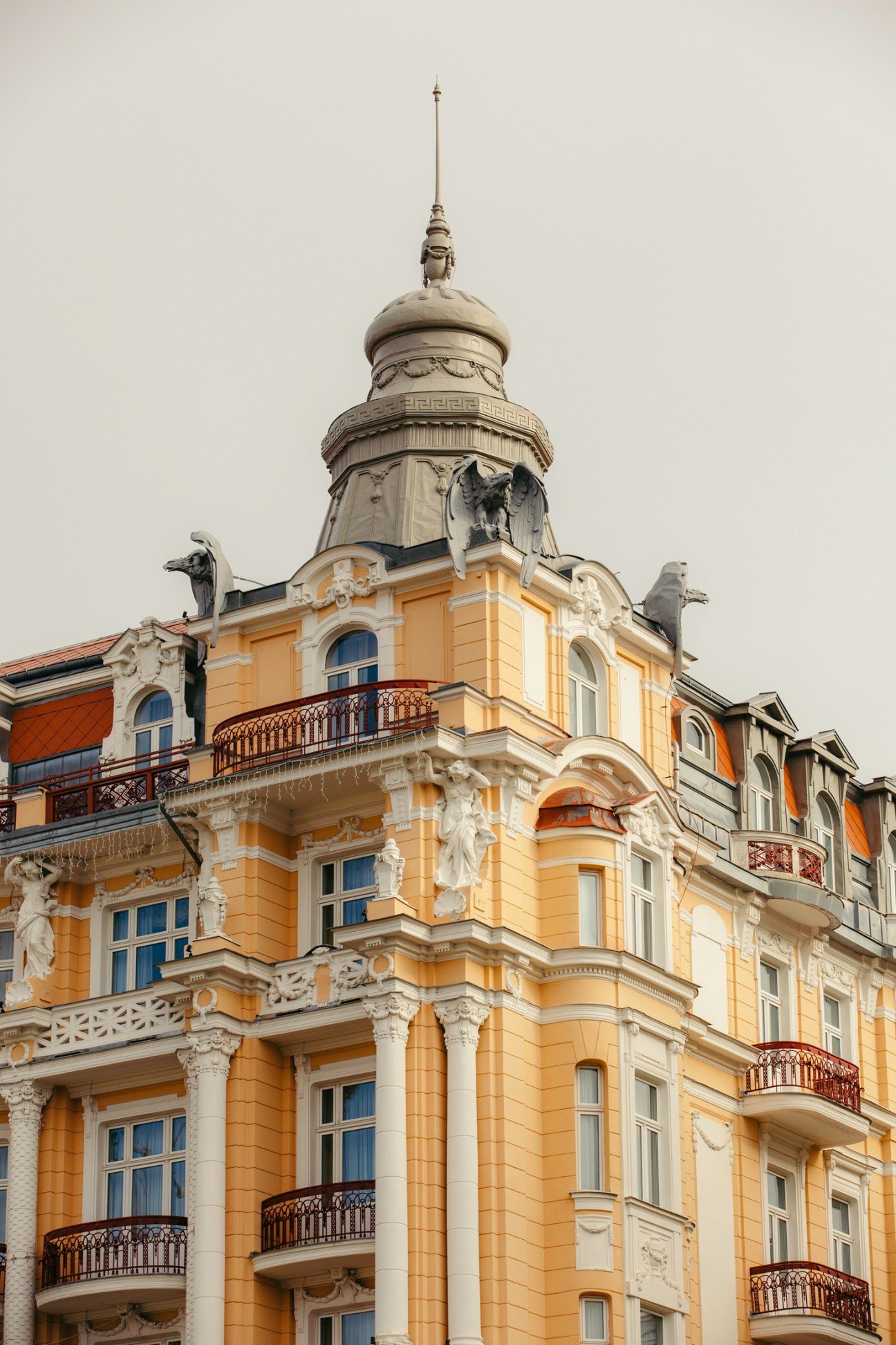 Neo-Renaissance façade of Marienbad's Hvezda Hotel with ornate yellow building and decorative dome topped with spire