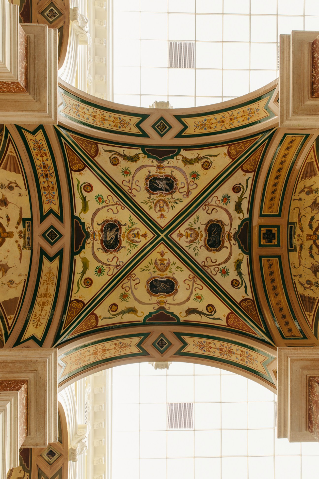 Ornate painted ceiling with decorative patterns and geometric designs in a historic spa interior