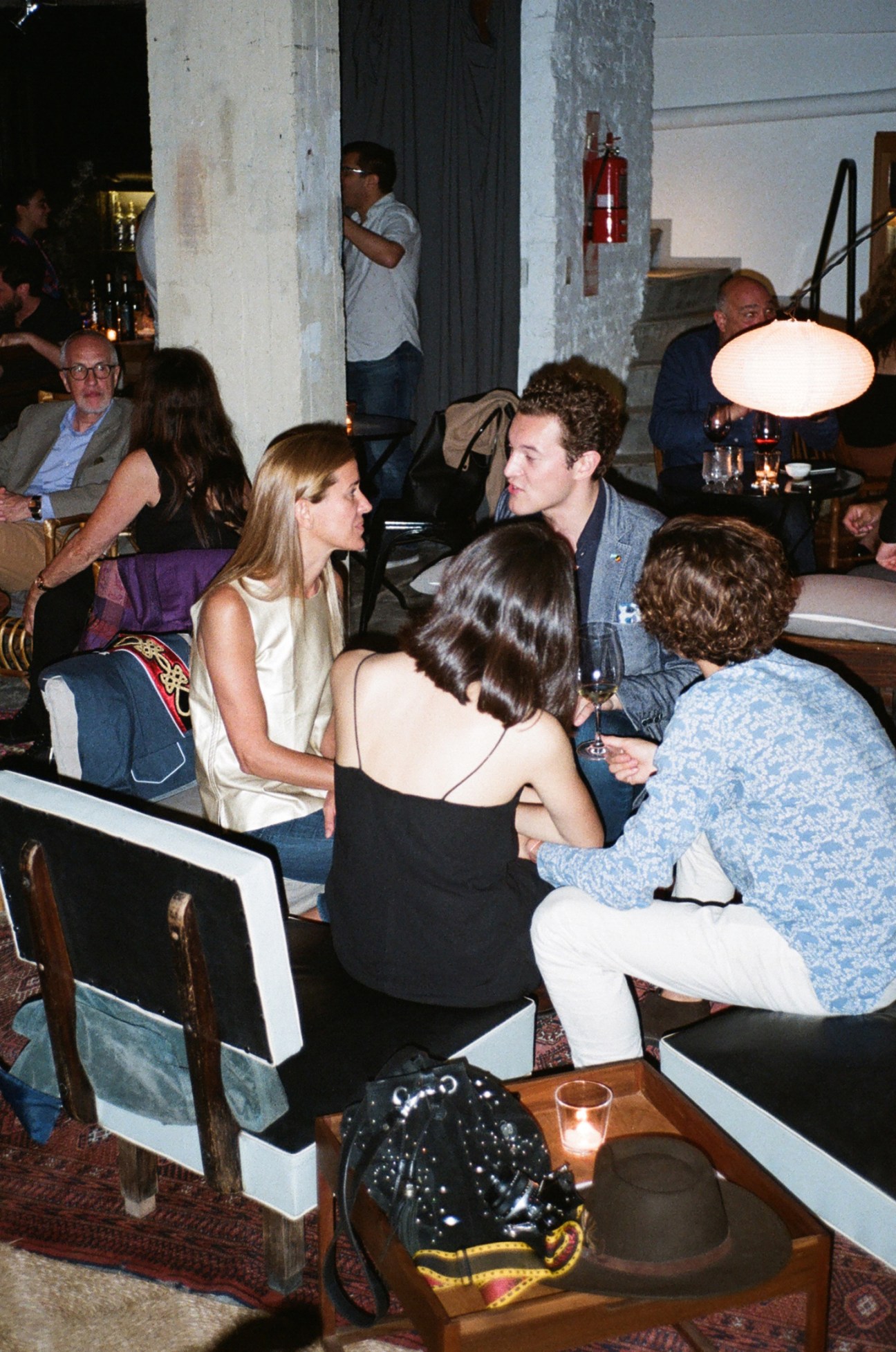 Patrons socializing and conversing at Black Forest listening bar in Buenos Aires
