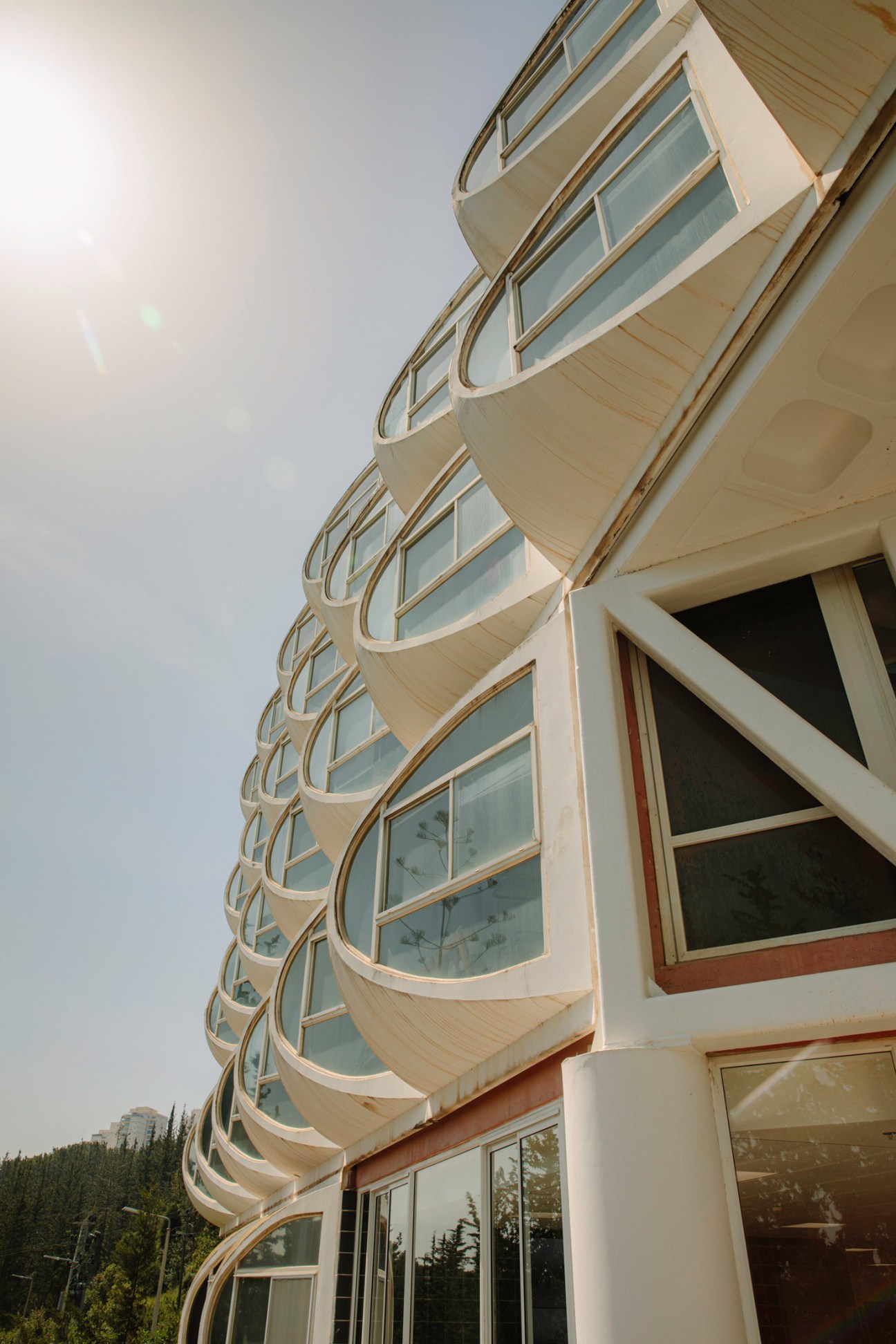 Modernist building with curved white balconies and large windows at the Technion.