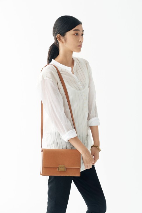 Woman wearing Saint Laurent shirt and bag with Schiesser vest and Laura Lombardi bracelet