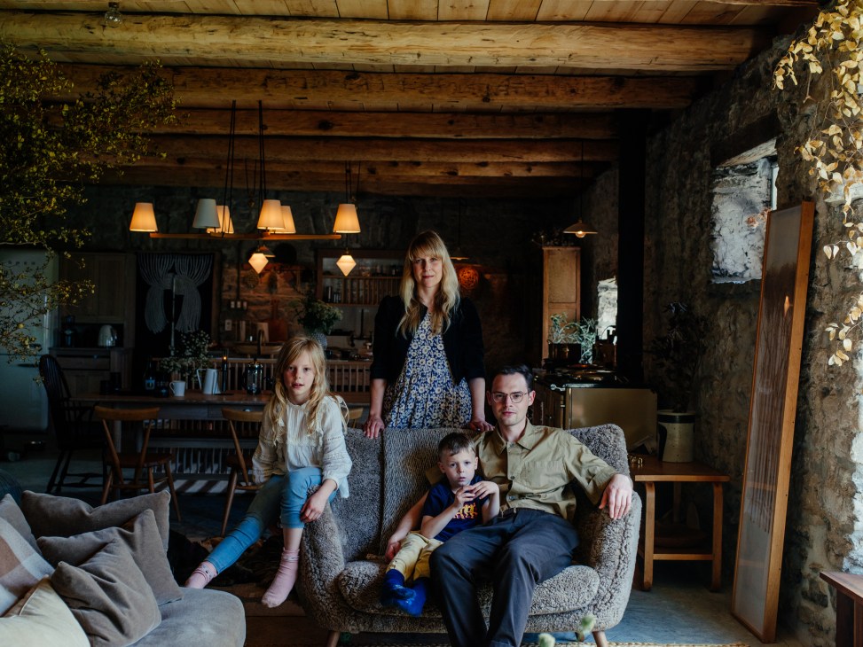 Juli Daoust Baker and John Baker with children Elodie and Howell in their rustic farmhouse living room