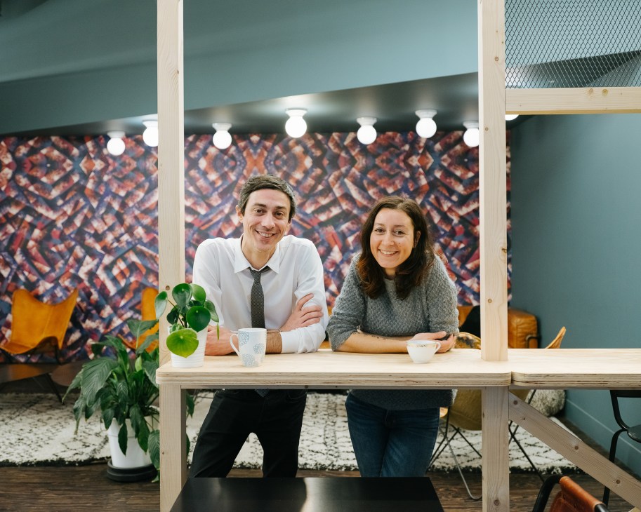 Adrien Poggetti and Magali Olivier stand at a desk inside La Cantine, a co-working space in Nantes.
