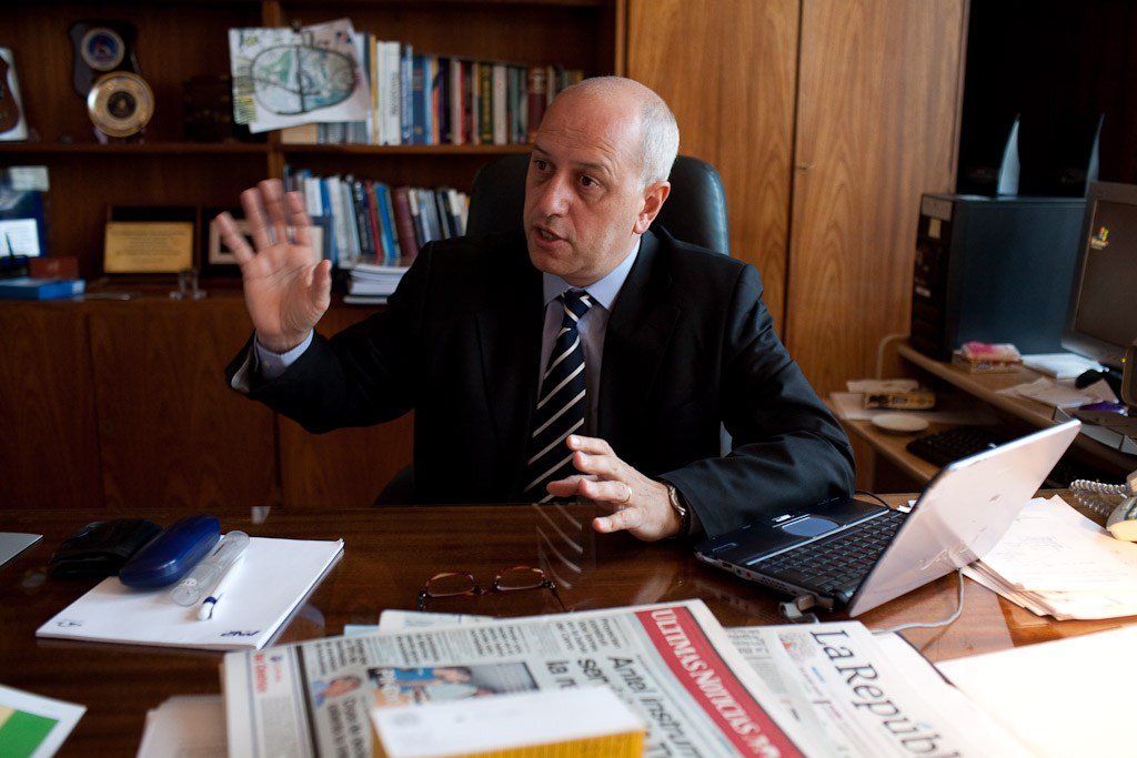 Dr Fernando Puntigliano, president of Uruguay's National Port Authority, gestures while speaking at his wood-paneled office desk.
