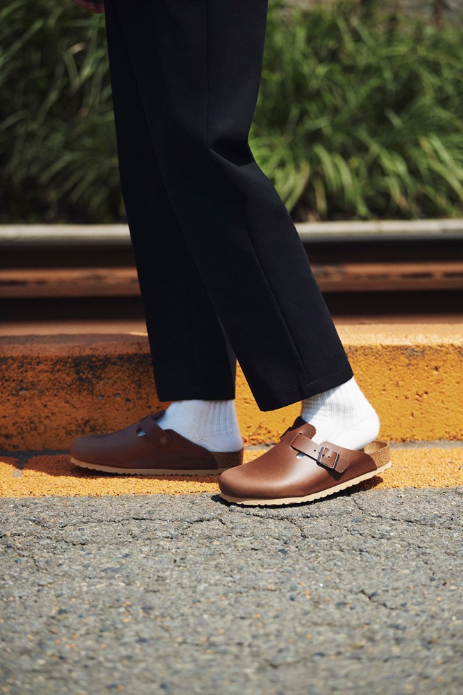 Minimalist lower body styling with tailored trousers and sandals