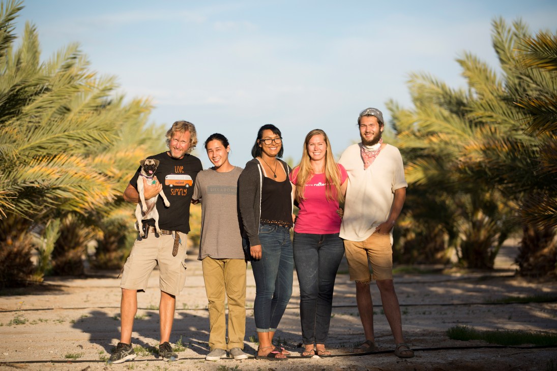 Five members of the Naked Dates family pose in a date palm grove in Arizona.