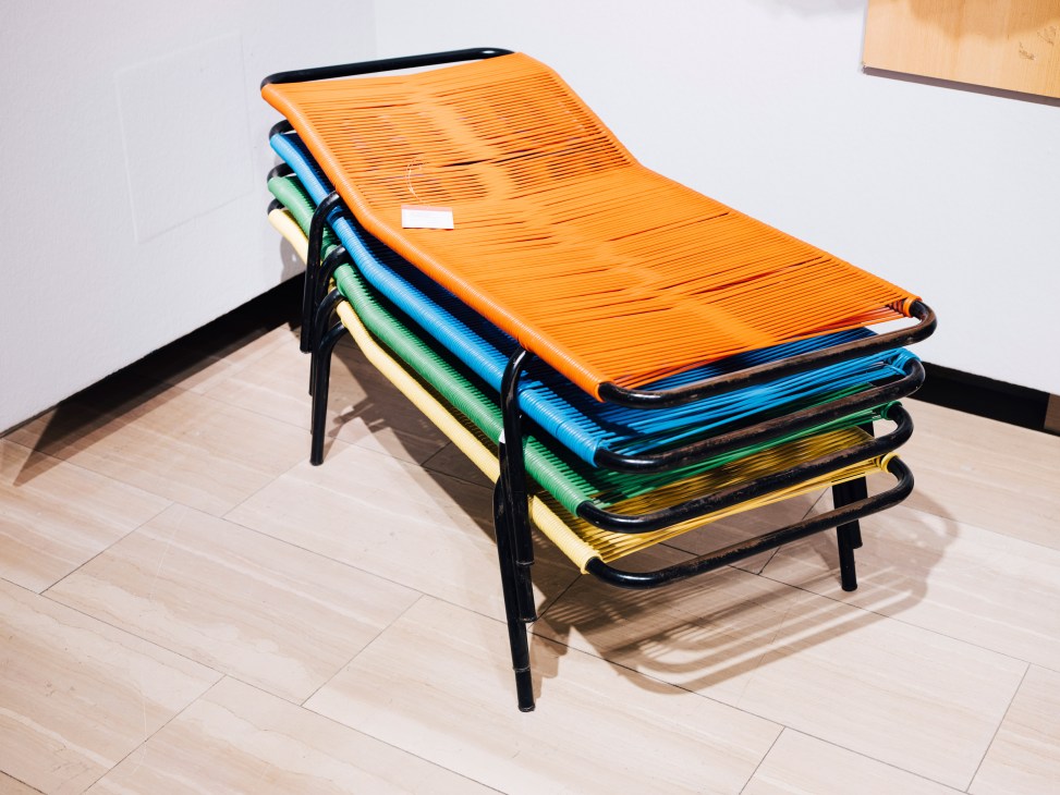 Stacked colorful modern lounge chairs with woven seats in orange, blue, green and yellow