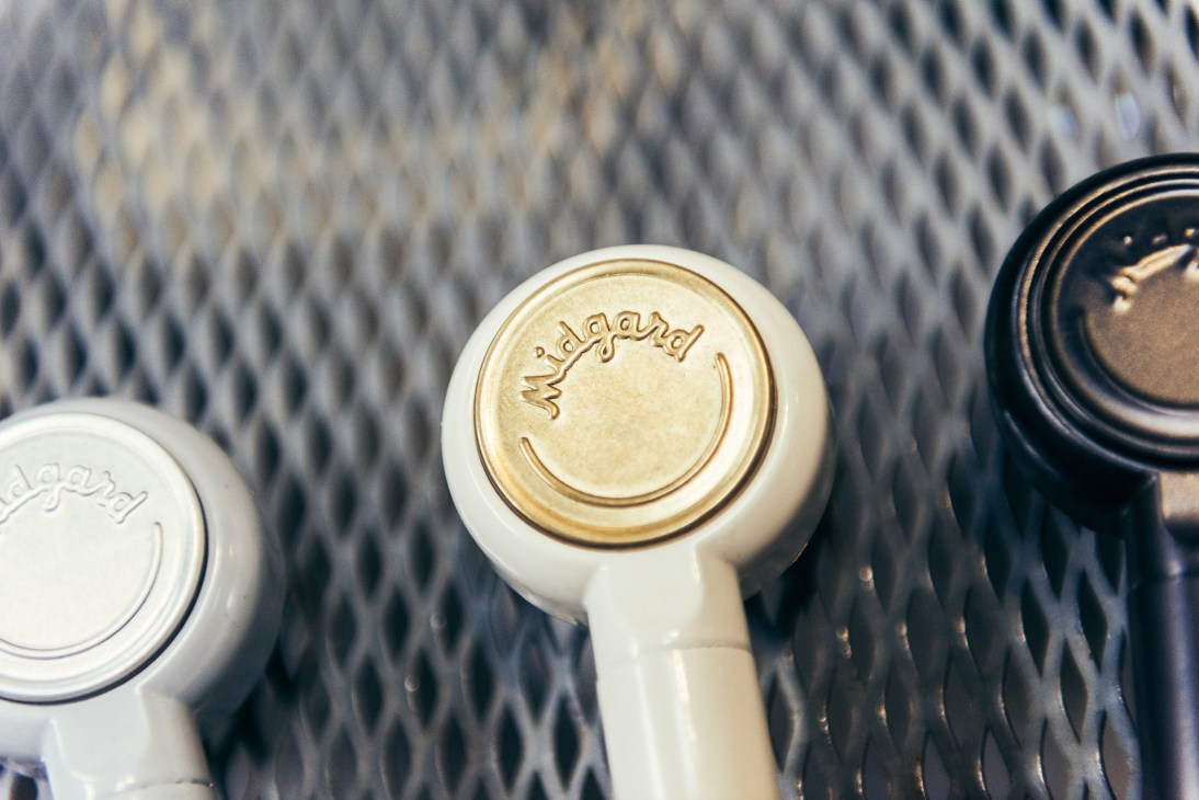 Close-up of Midgard lamp switch and control components in white and brass finishes.