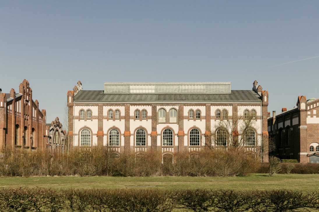 Red-brick industrial building with white stone facade and large windows, formerly a colliery engine hall transformed into Manufactum headquarters.