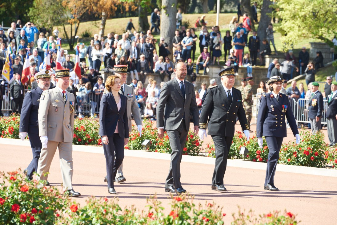 French Prime Minister Édouard Philippe walks with military officials and dignitaries during a Camerone Day ceremony parade.
