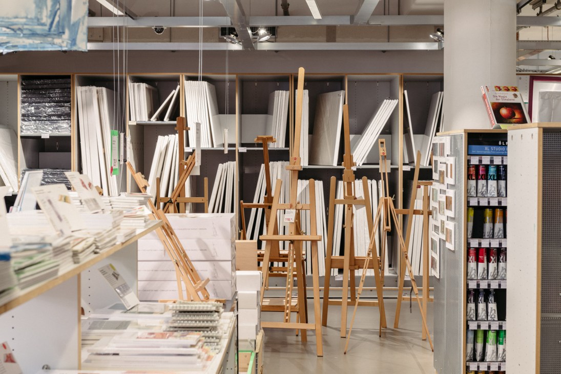 Wooden easels and paper sheets displayed in Modulor's Berlin stationery shop.
