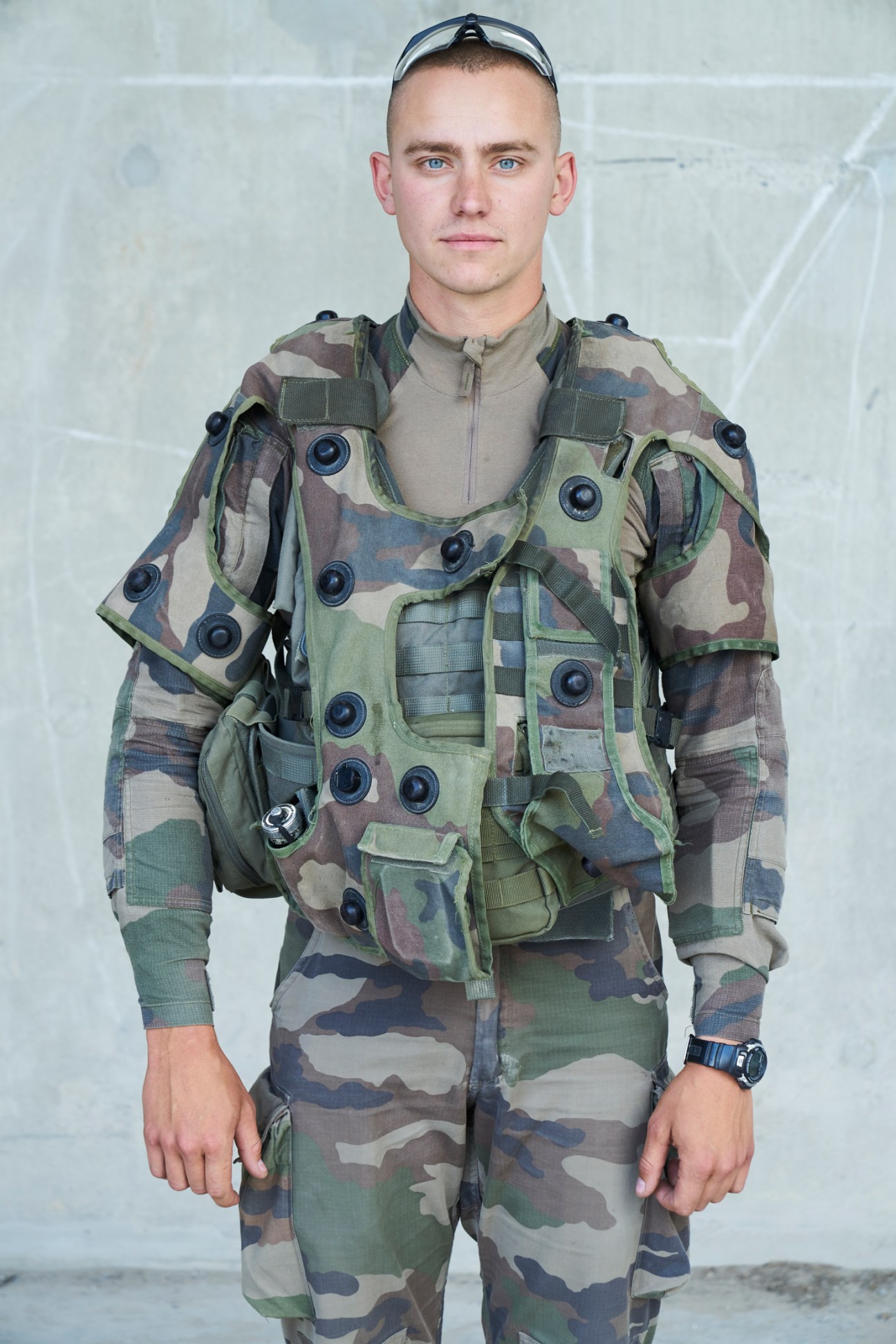 Young legionnaire in camouflage uniform and tactical vest with laser sensors for training exercises
