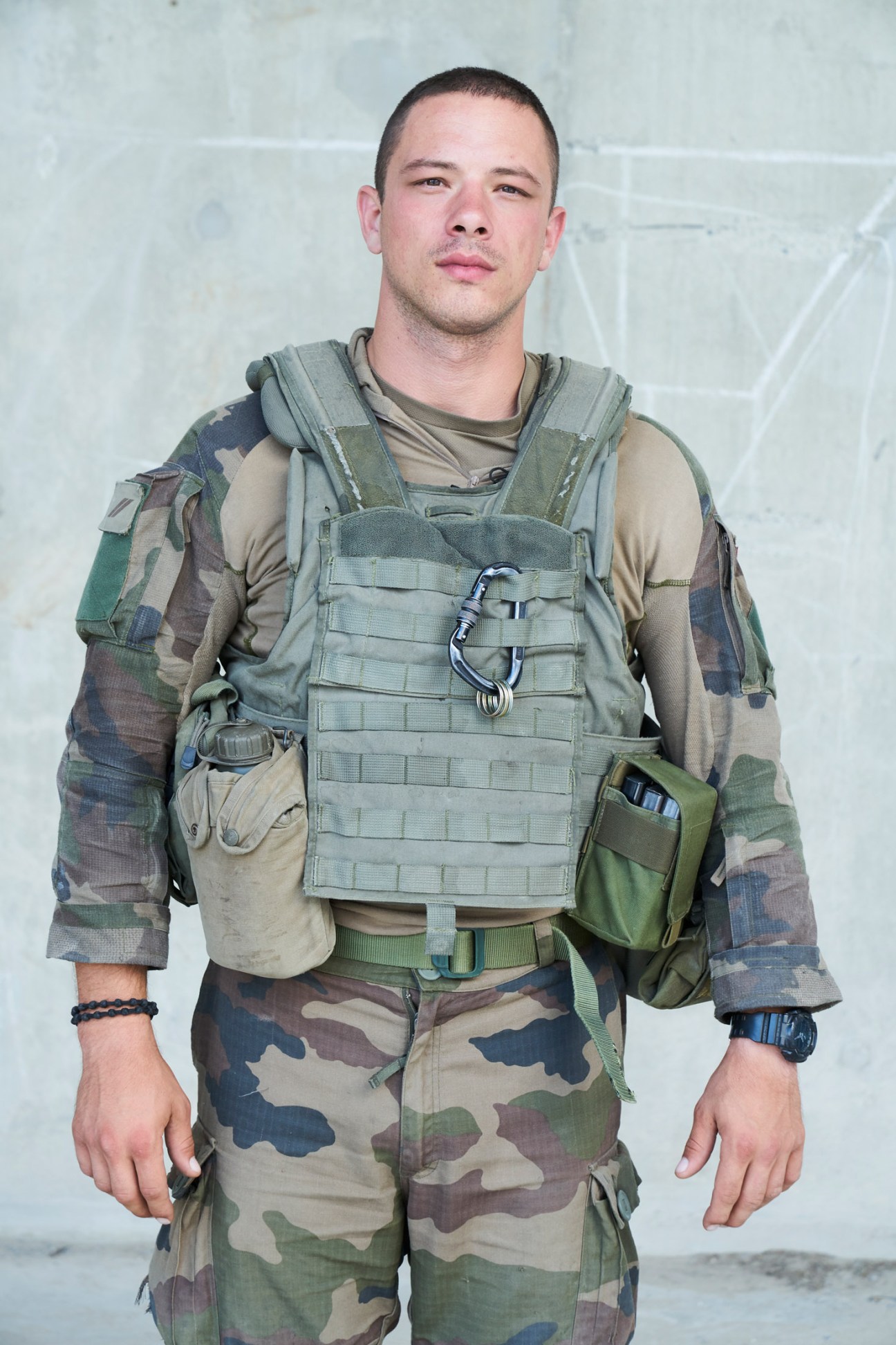 Young legionnaire Vasilije in combat uniform with tactical vest and camouflage fatigues