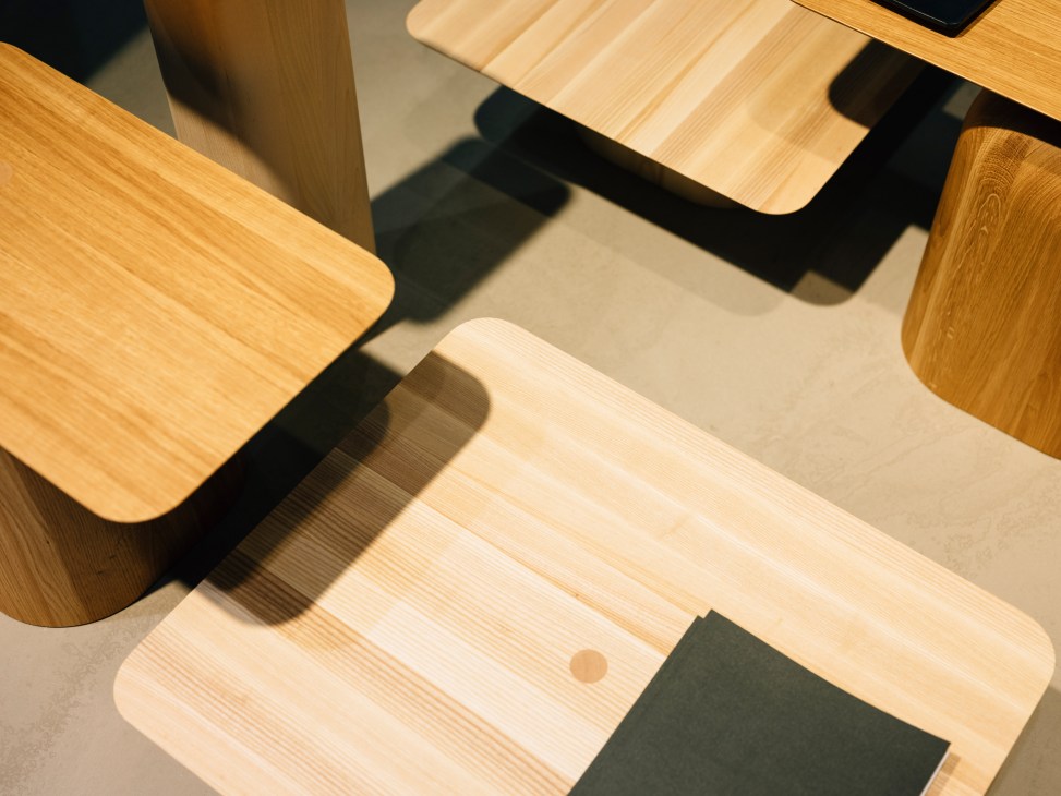 Overhead view of light wooden furniture pieces with rounded edges and natural grain visible.