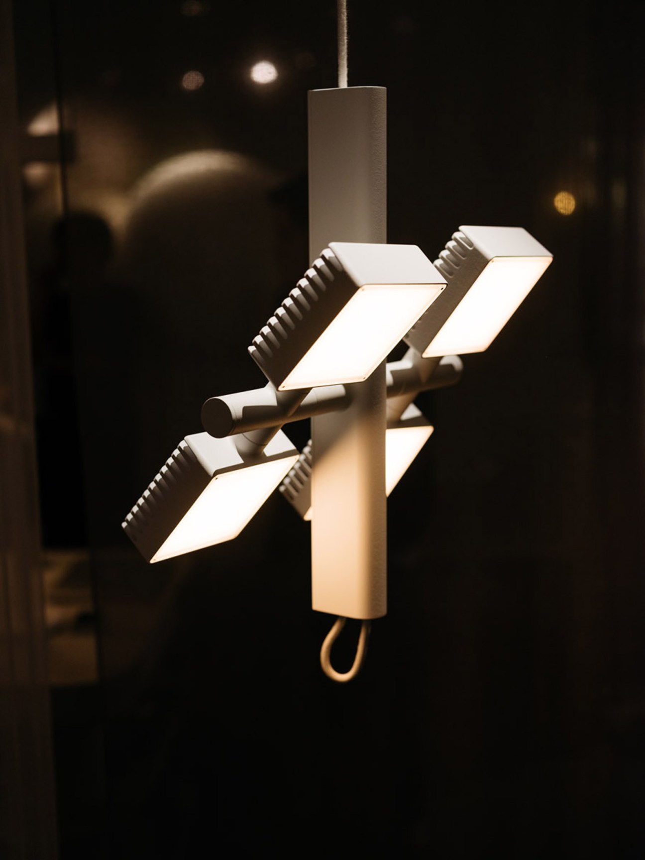 Modern pendant lighting fixture with white panels and dark metal fixtures designed by SCMP Designoffice for Lambert & Fils Studio
