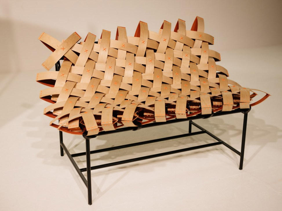 Wooden woven bench with metal frame and orange-marked wooden strips creating a spiky silhouette