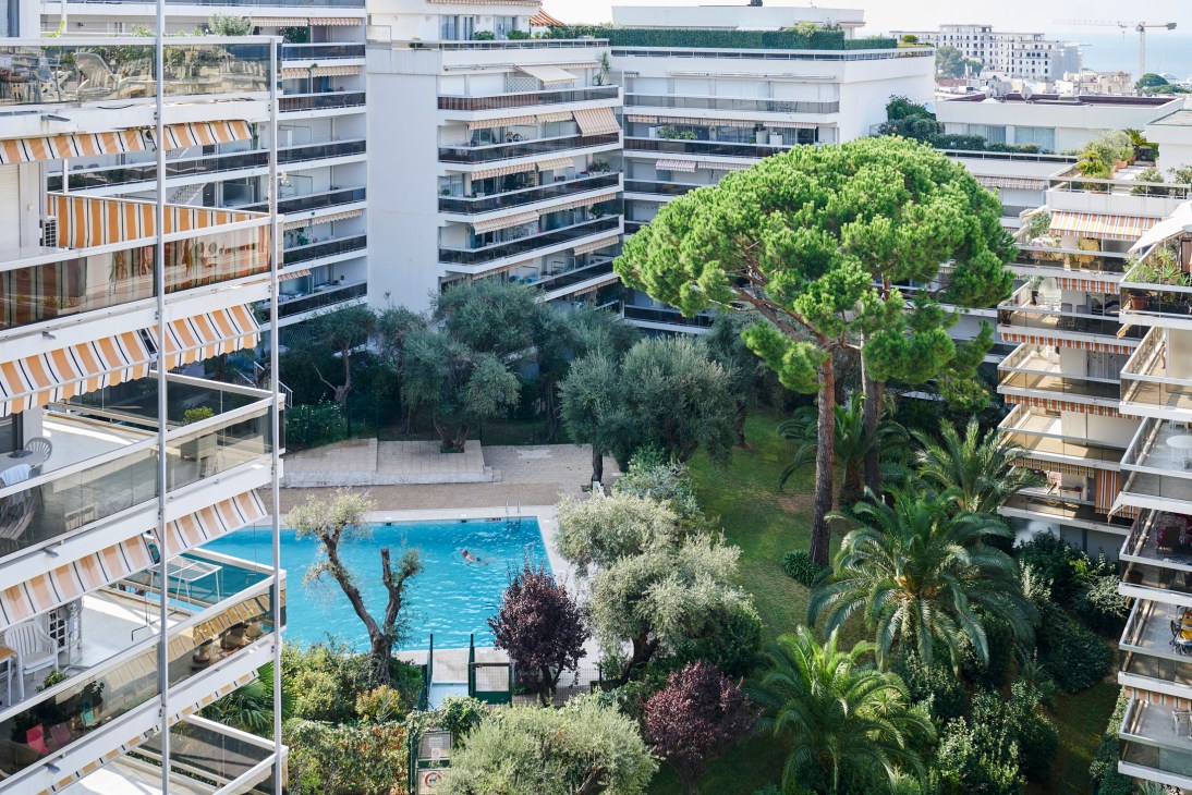 Swimming pool surrounded by lush Mediterranean greenery at Mas de Tanit holiday complex