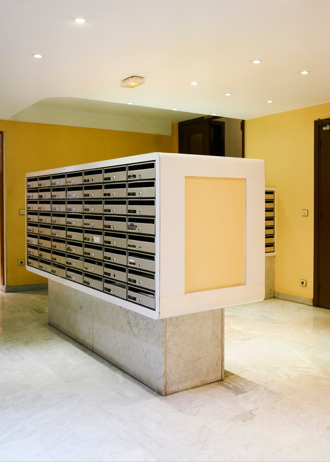 Wall of mailboxes at apartment building entrance at Mas de Tanit complex