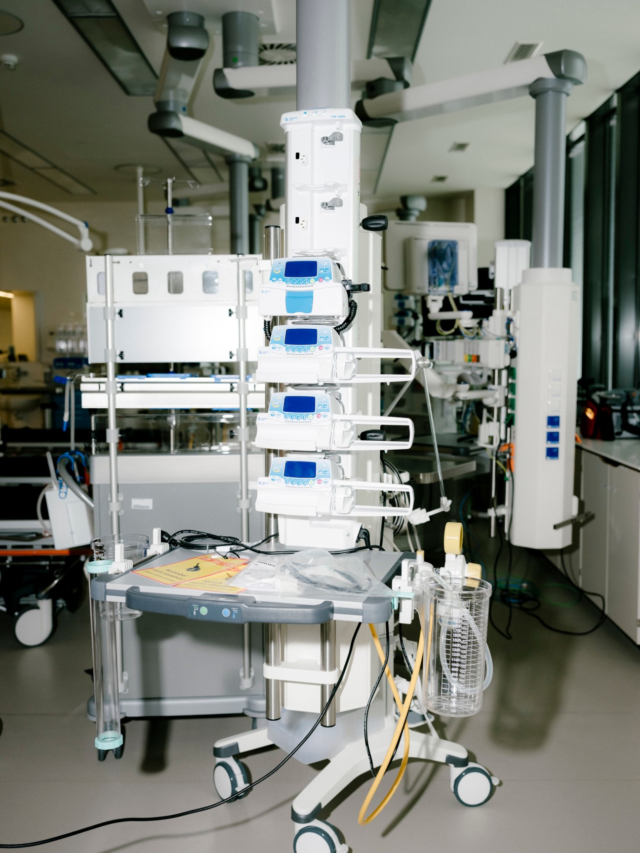 State-of-the-art medical monitoring equipment with blue digital displays stacked vertically in a modern hospital laboratory.