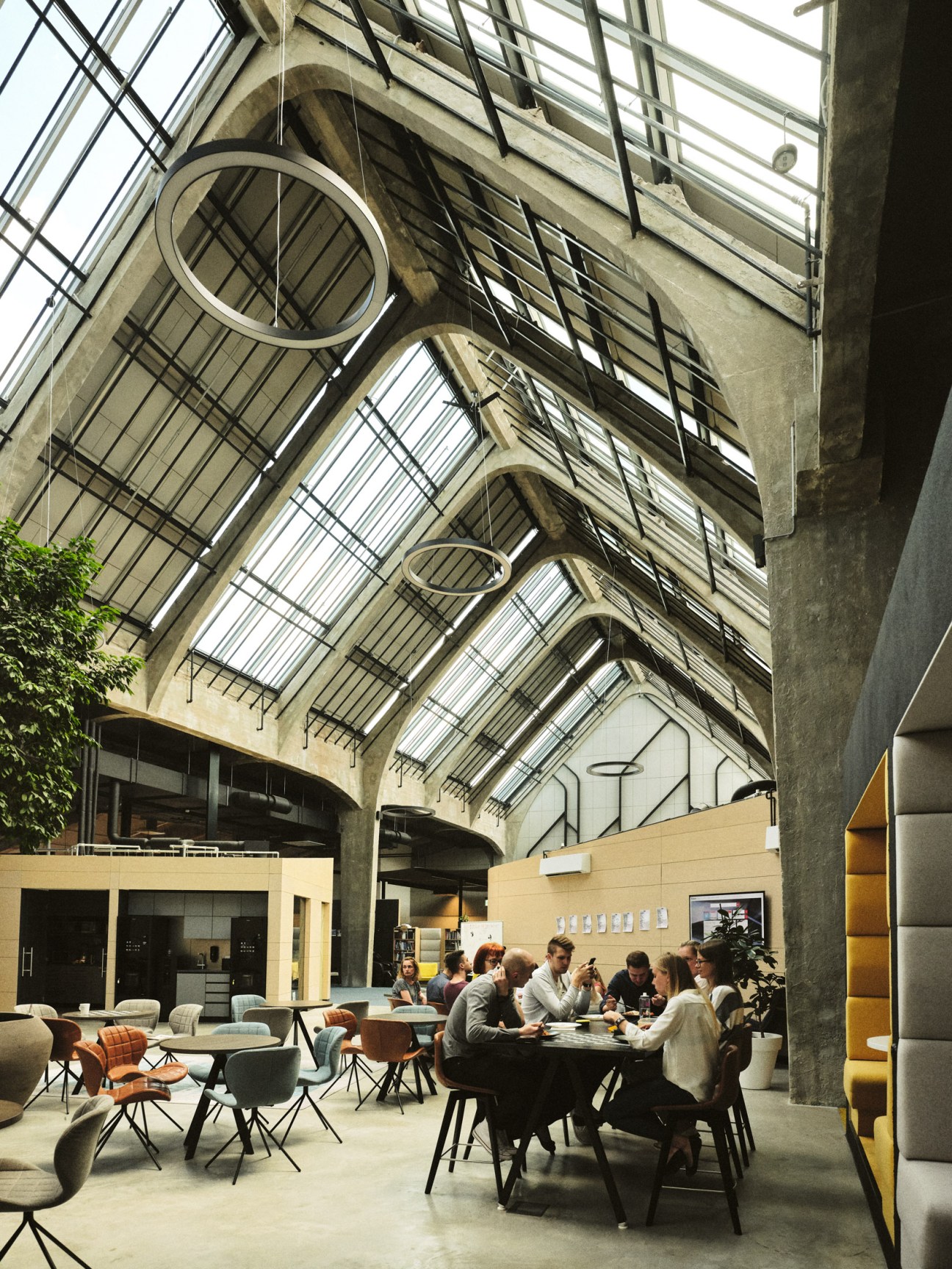 Open kitchen area with modern fittings and communal seating in an office space