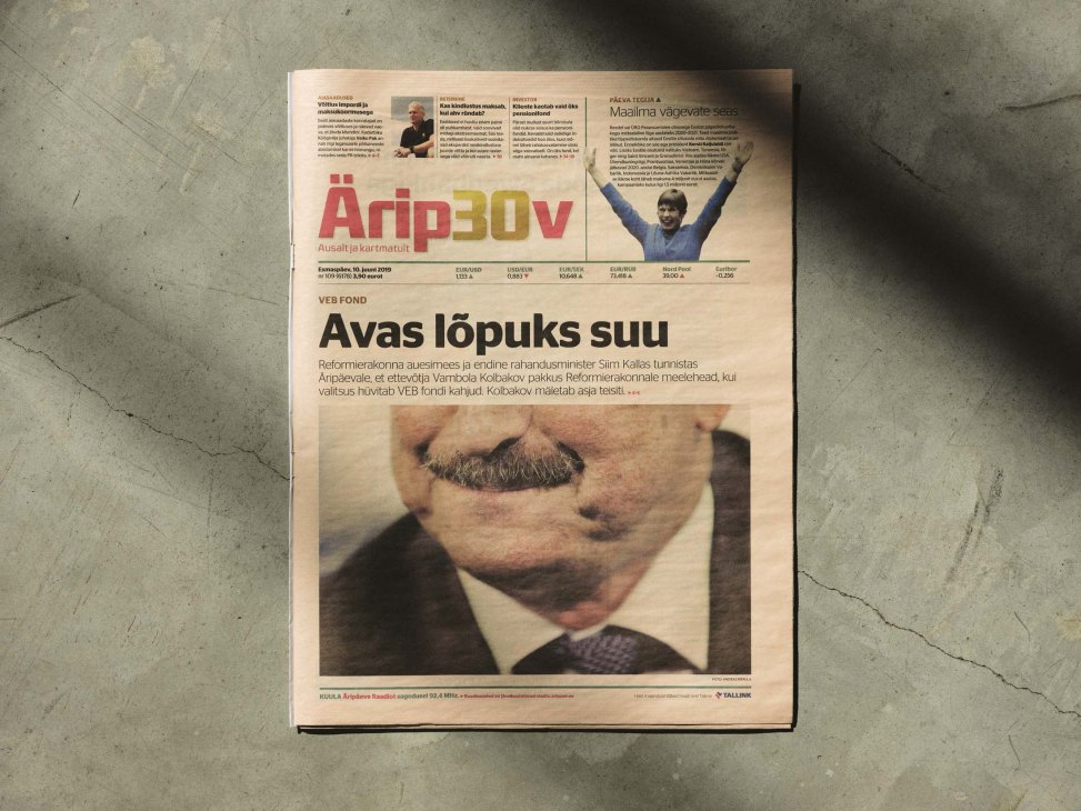 Aripaev newspaper front page displayed on concrete floor showing 30th anniversary edition with Estonian headline and business news
