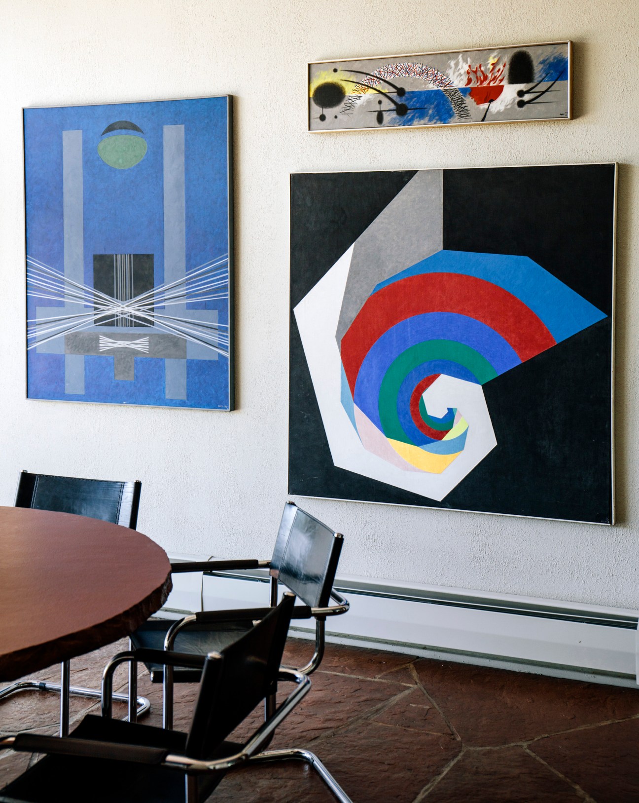 Interior of Egbert Jacobson residence showing colorful geometric artworks on walls and modernist furniture.