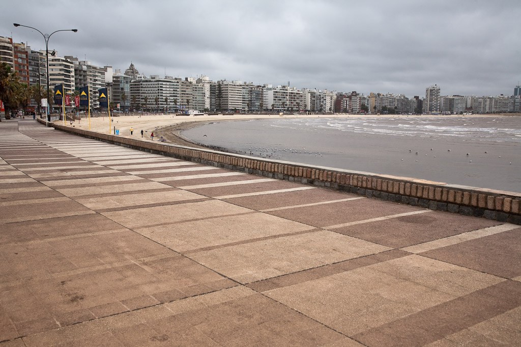 Montevideo's Rambla promenade with apartment buildings and beach along the Río de la Plata.