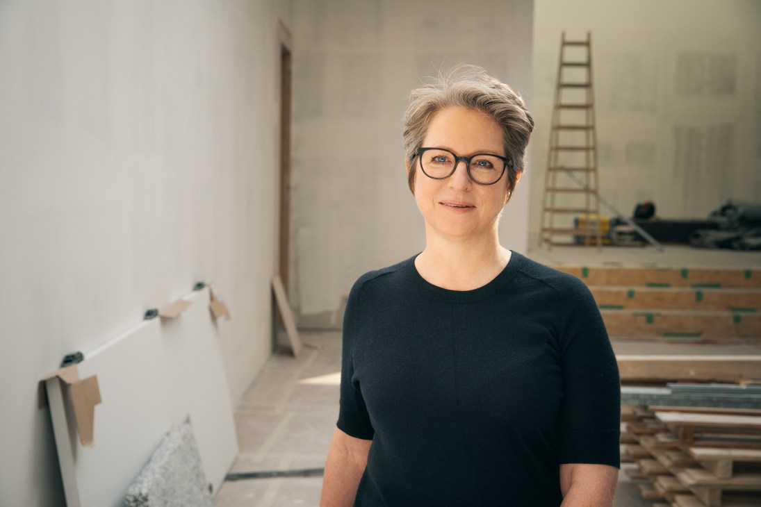 Esther Schipper, gallerist, stands in her Berlin gallery space with construction materials visible in the background.