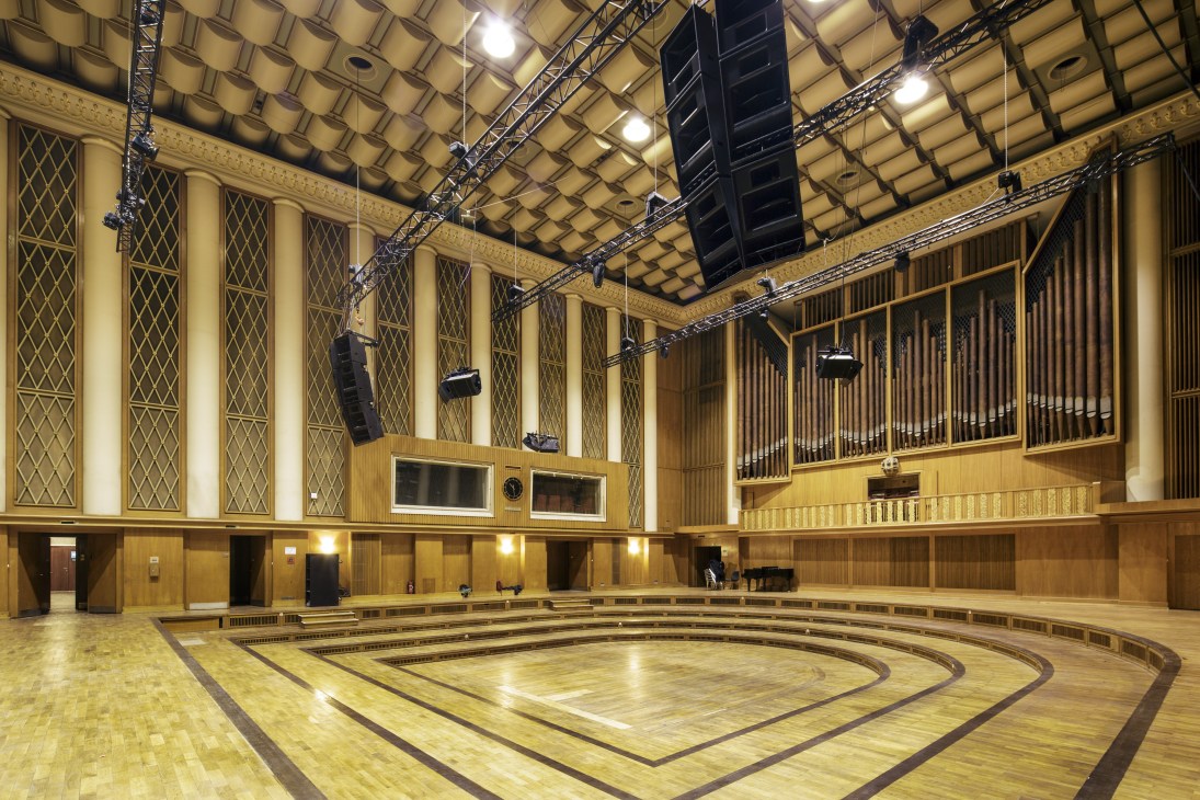 Studio 1 recording hall with wooden interior, acoustic panels, and professional audio equipment suspended from ceiling