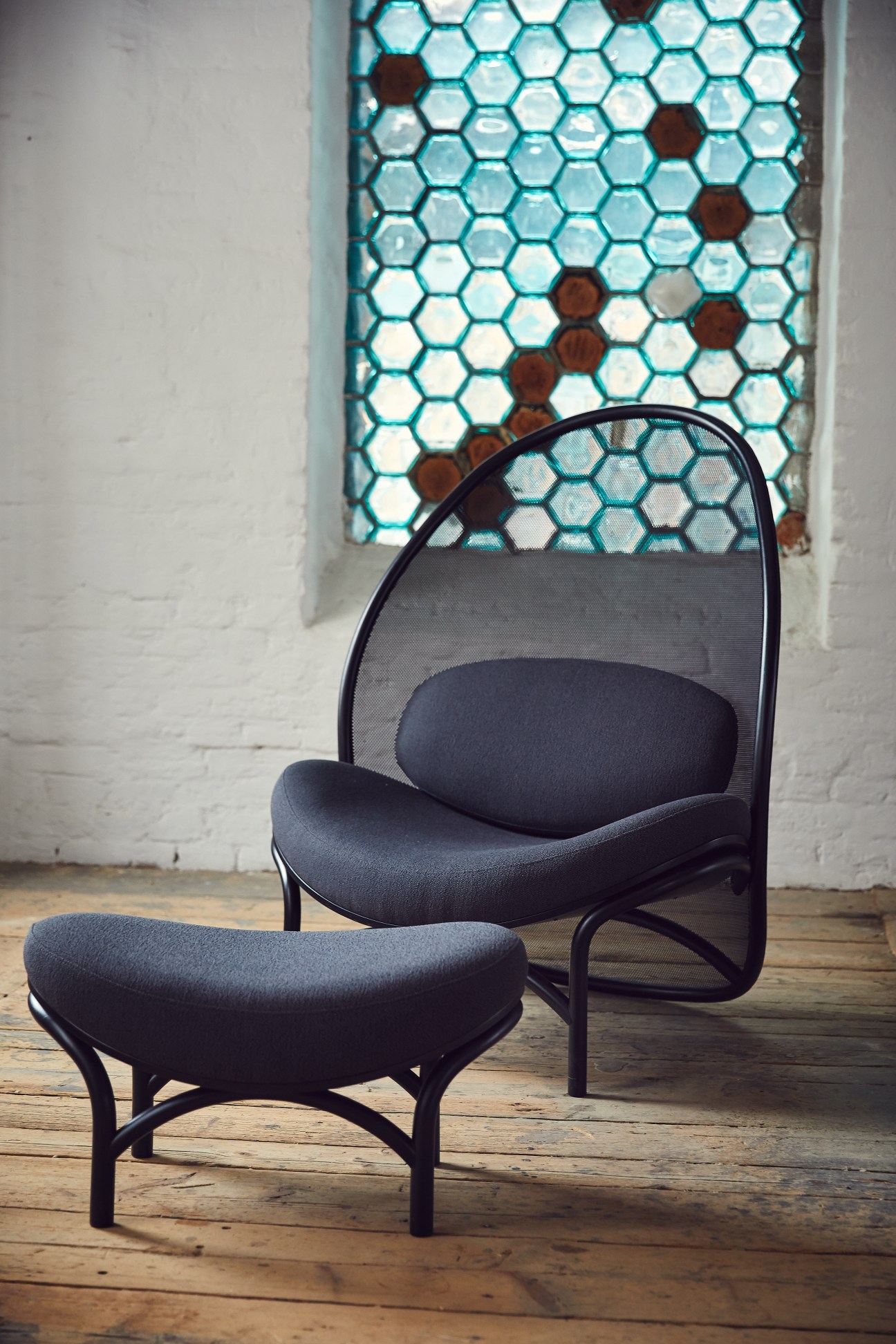 Ton's Chips lounge chair by Lucie Koldova with netted backrest and curved timber frame.