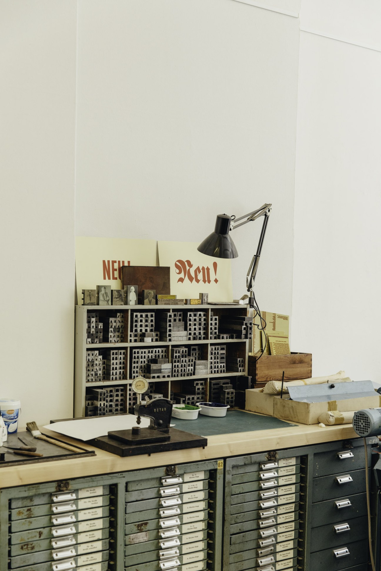 Vintage letterpress type drawers filled with metal printing elements organized in wooden compartments.