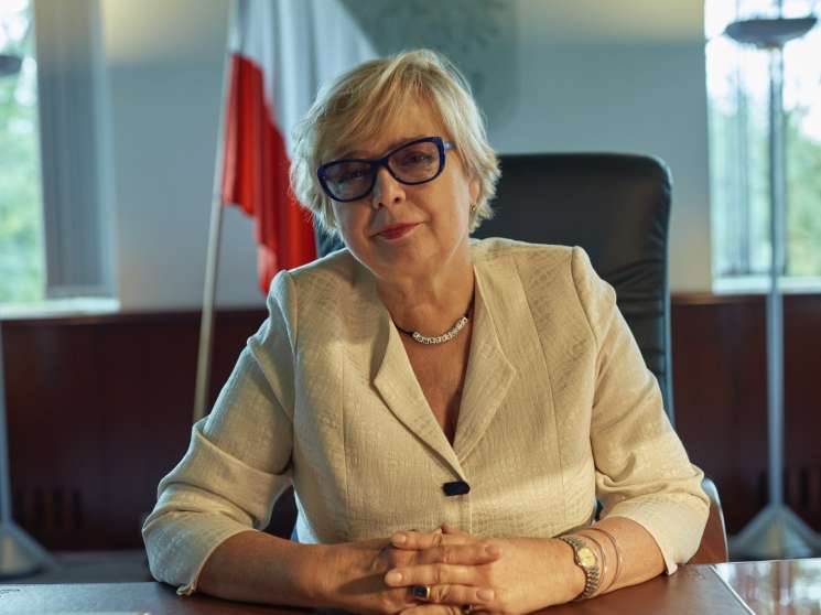 Malgorzata Gersdorf, Poland's Supreme Court president, seated at her desk wearing a beige blazer with a constitution beads necklace.