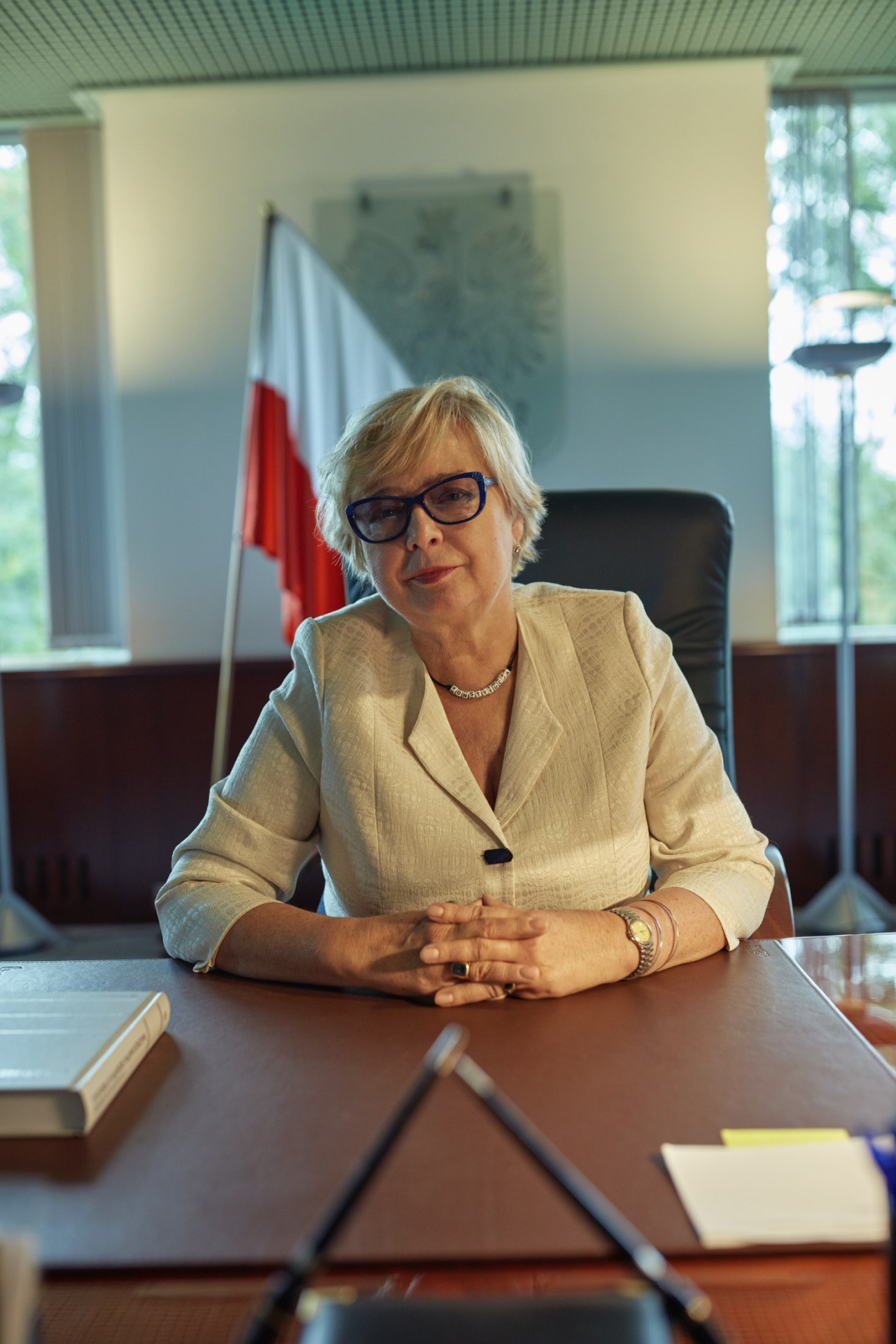 Malgorzata Gersdorf, Poland's Supreme Court president, seated at her desk wearing a beige blazer with a constitution beads necklace.