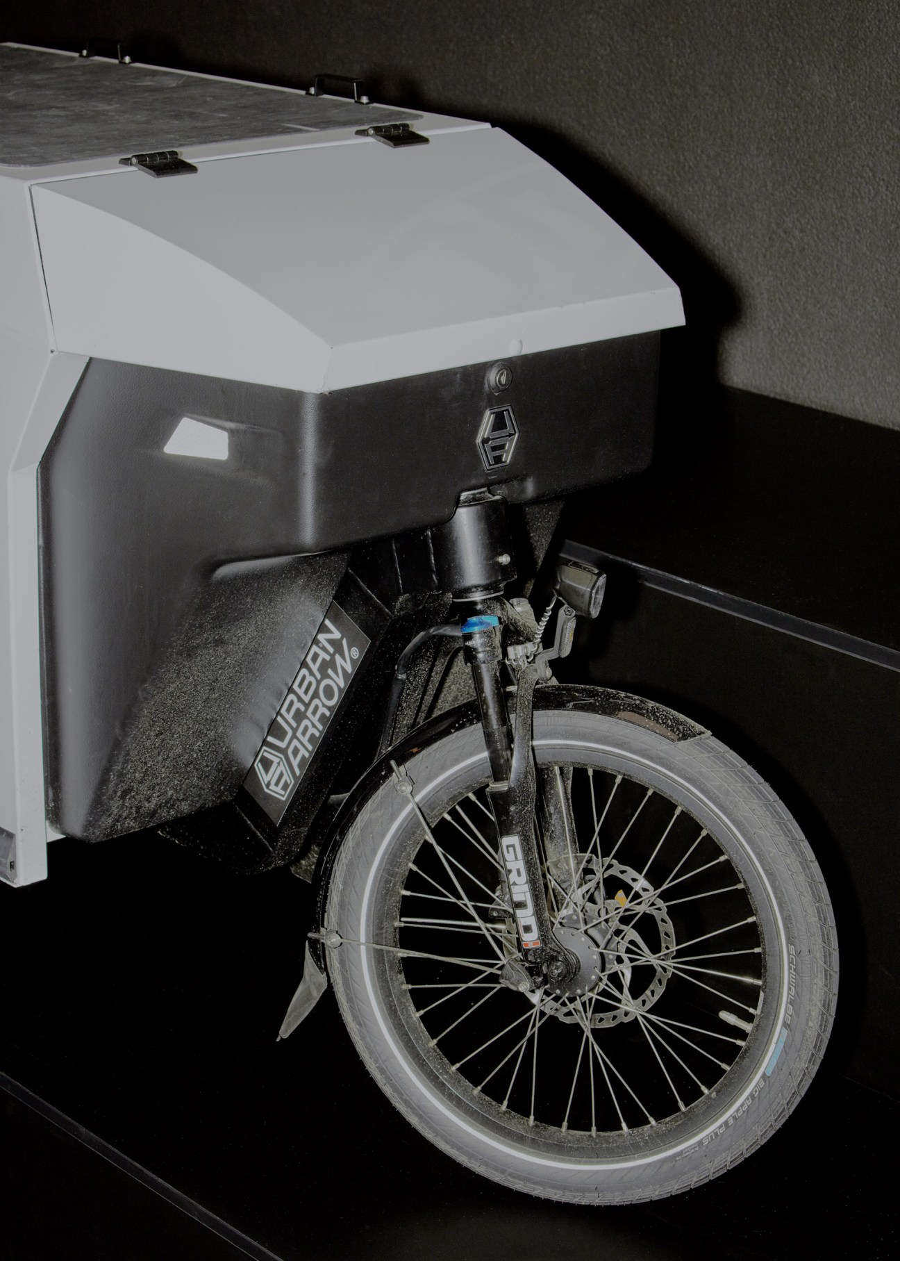 Urban Arrow cargo bike with white storage box and black frame showing its spacious cargo capacity design.
