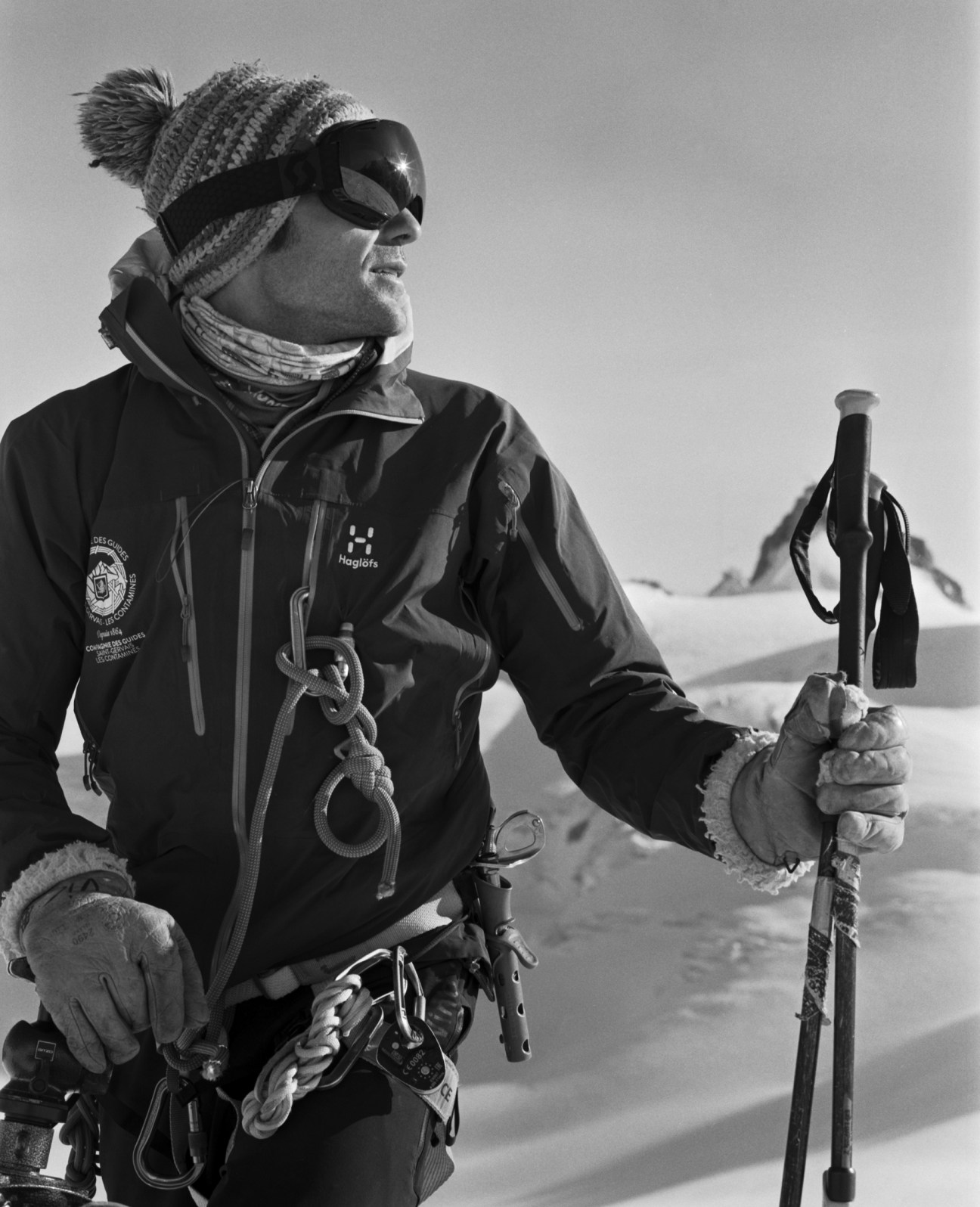 Mountain guide Victor Lapras in winter gear with climbing equipment and poles on a snowy alpine slope.