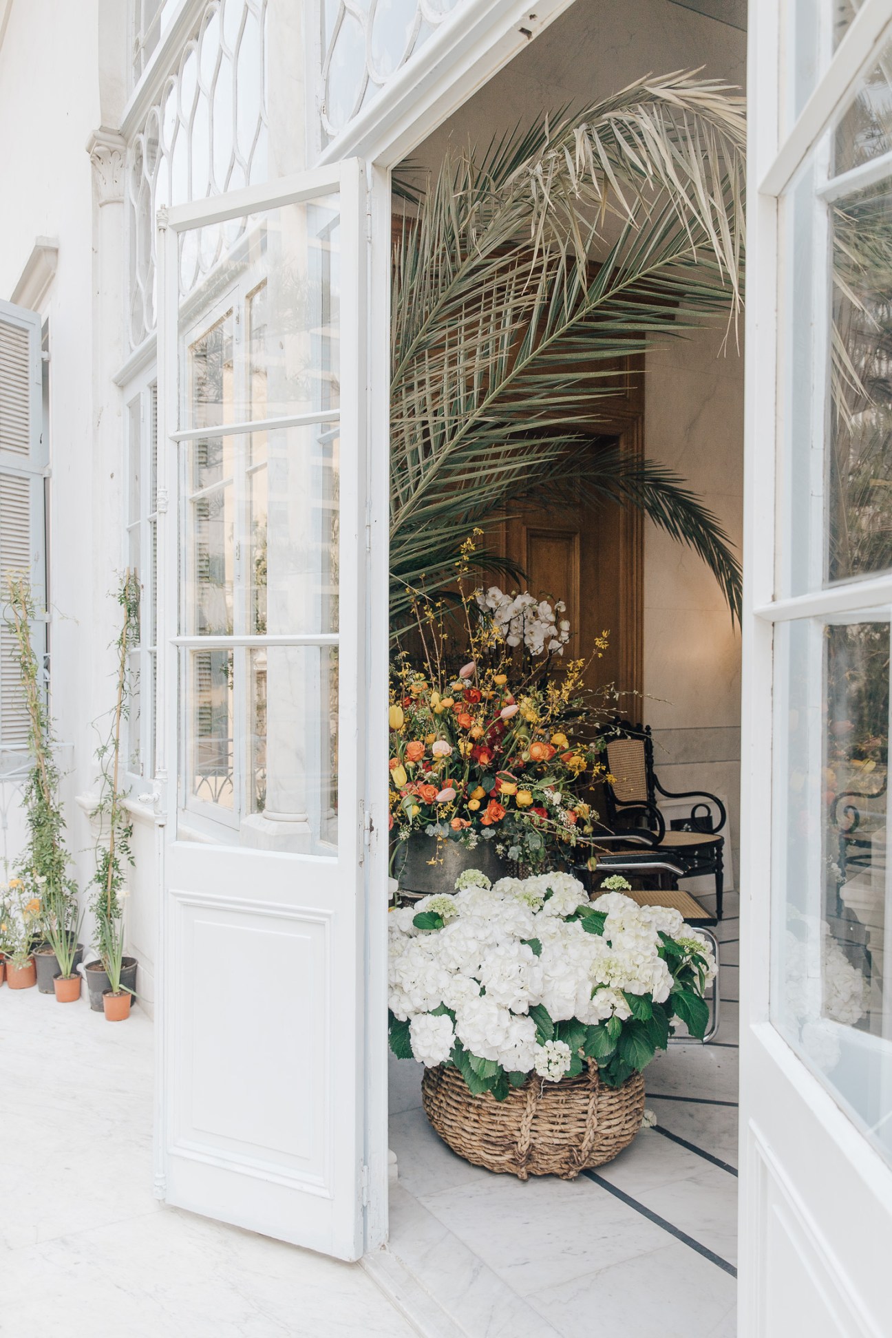 White hydrangeas in a woven basket at the entrance to Maison Rabih Kayrouz boutique in Beirut.