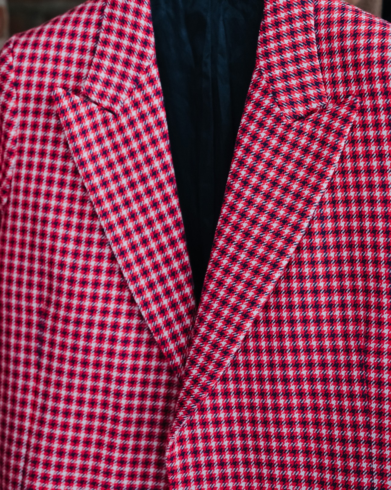 Close-up of red and white houndstooth tweed jacket from Ami's womenswear collection.