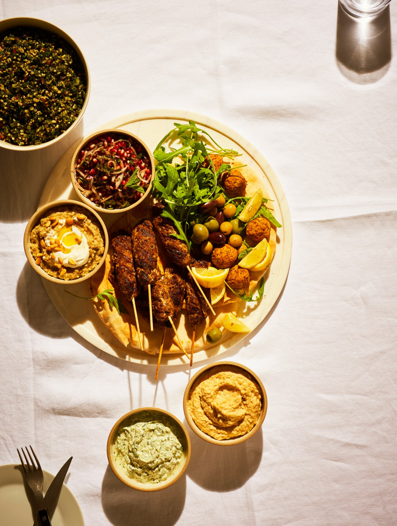 Assorted cooking ingredients and recipes displayed on a white surface including vegetables, grains and prepared dishes