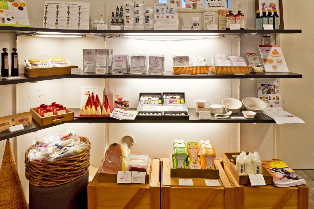 Retail display shelves showing organic canine health foods, supplements, and toiletries at Kitchen Dog! shop in Tokyo.