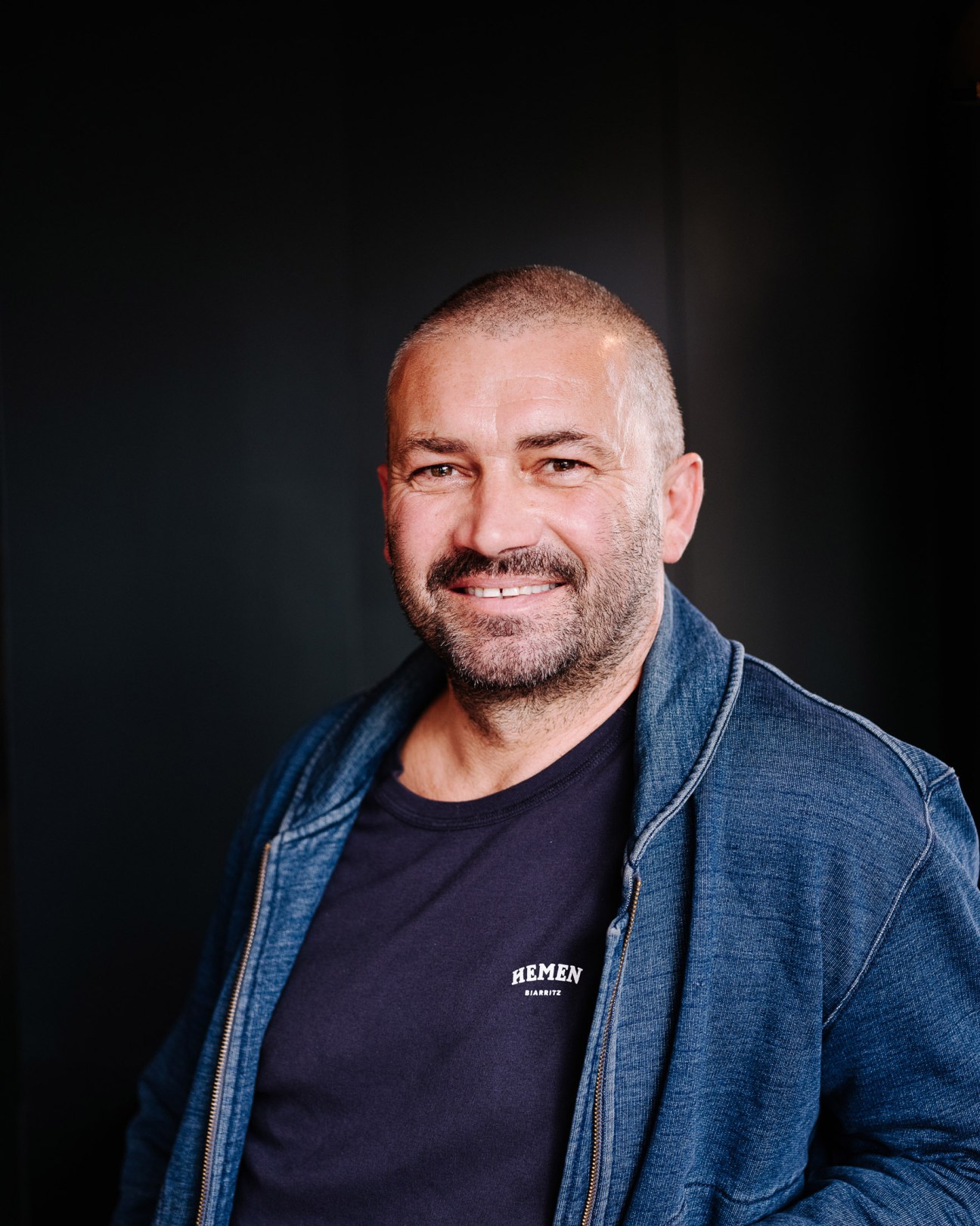Emmanuel Mouazan, co-founder of Hemen underwear label, wearing a denim jacket and Hemen t-shirt