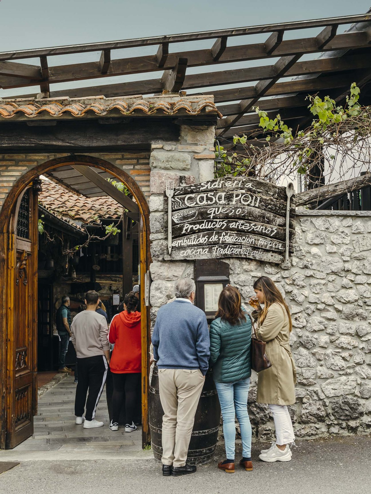 People queuing outside Casa Poli restaurant for lunch