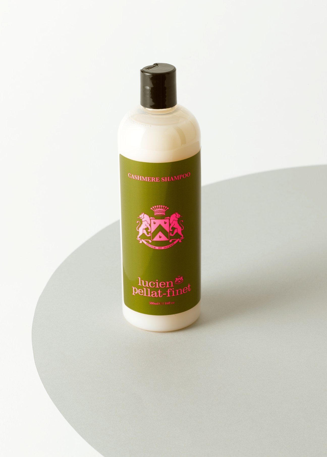 Lucien Pellat-Finet cashmere shampoo bottle with olive green label and black cap on white surface.