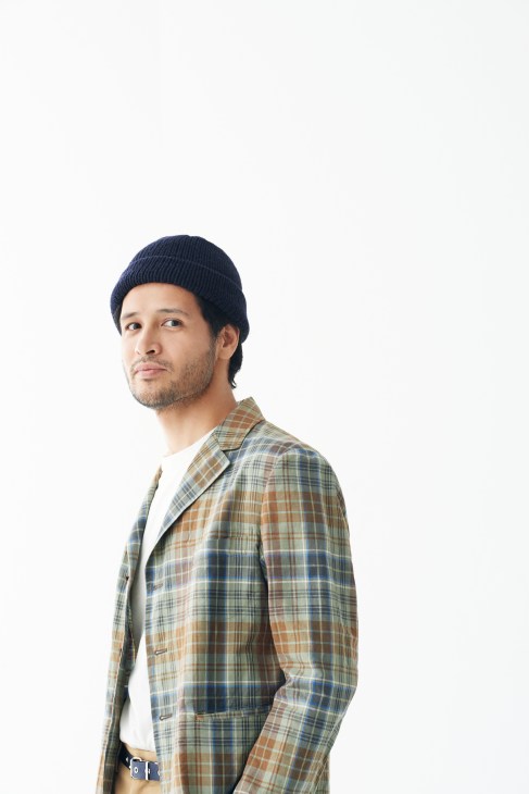Man wearing plaid jacket by Scye, white shirt by Niuhans, and navy knitted hat by Comesandgoes.