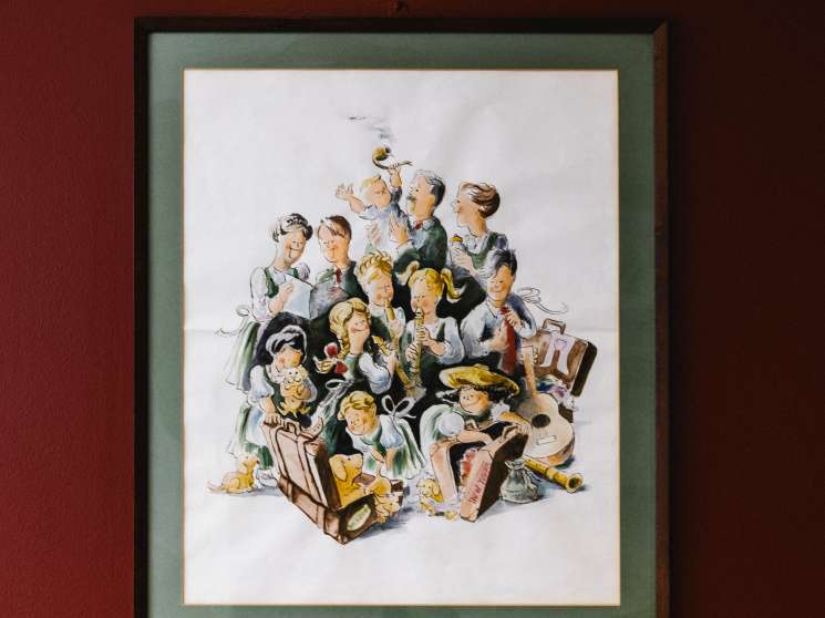 Framed illustration showing the Von Trapp Family Singers in traditional Austrian clothing gathered together