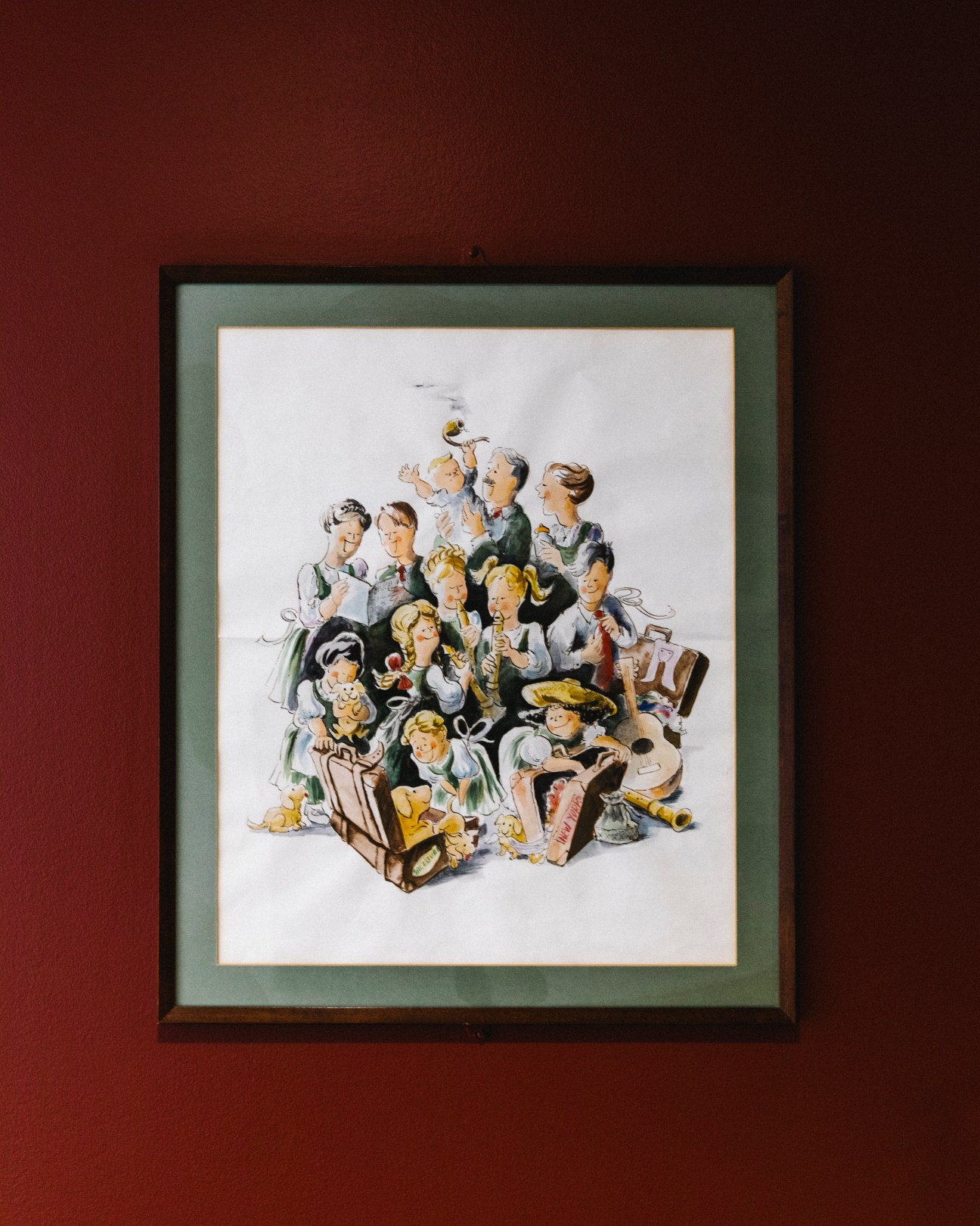 Framed illustration showing the Von Trapp Family Singers in traditional Austrian clothing gathered together