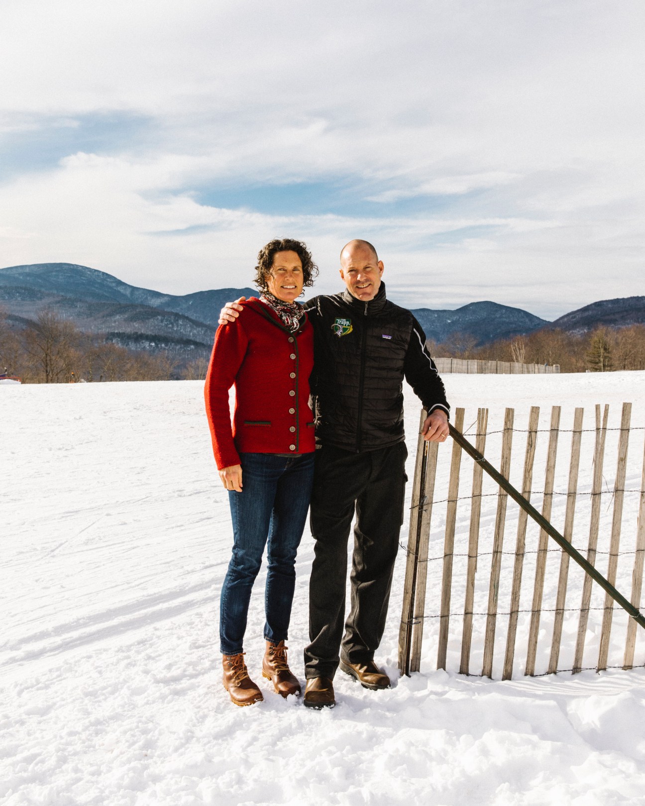 Kristina von Trapp Frame and Sam von Trapp standing together in snow with mountains and fence behind them