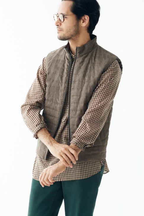 Man wearing Herno gilet, Auralee shirt, PT01 trousers and Eyevan 7285 glasses.