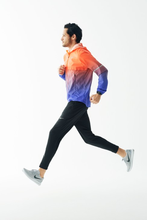 Man jogging in Nike jacket, trousers and trainers with Apple Watch Nike+