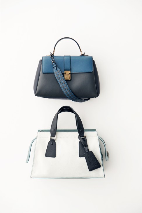 Two handbags displayed vertically: a blue and black Bottega Veneta top-handle bag above a cream and teal Giorgio Armani tote.